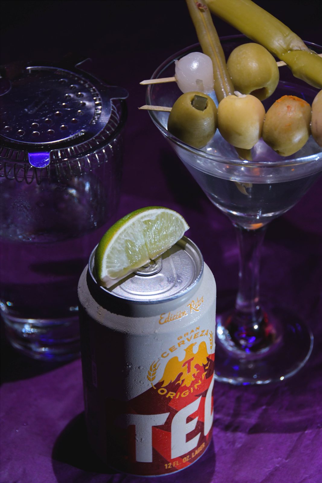 A Tecate can with lime beside a martini